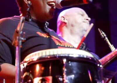 Singer and percussion player in a live show