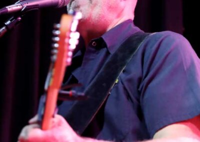Guitar and vocals in a live show