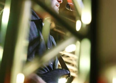 Guitar player seen through a scaffold frame